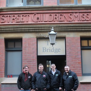 Oliver Pazio, Insurance Revolution analyst; Mark Rigby, Insurance Revolution head operating officer; Paul Dunn, company director and Paul Chambers, Well Dunn team leader, outside the Wood Street Mission building.