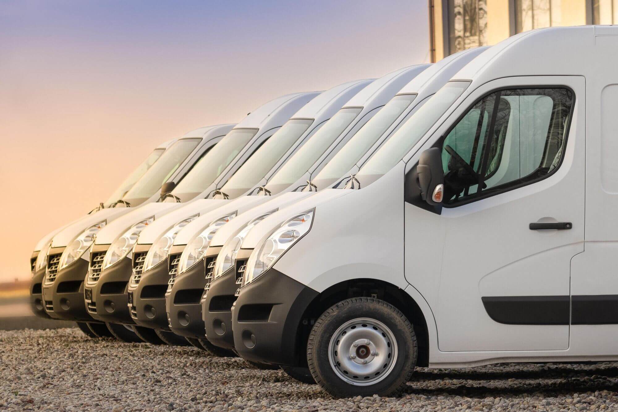 fleet of vans parked to deliver hermes or amazon goods