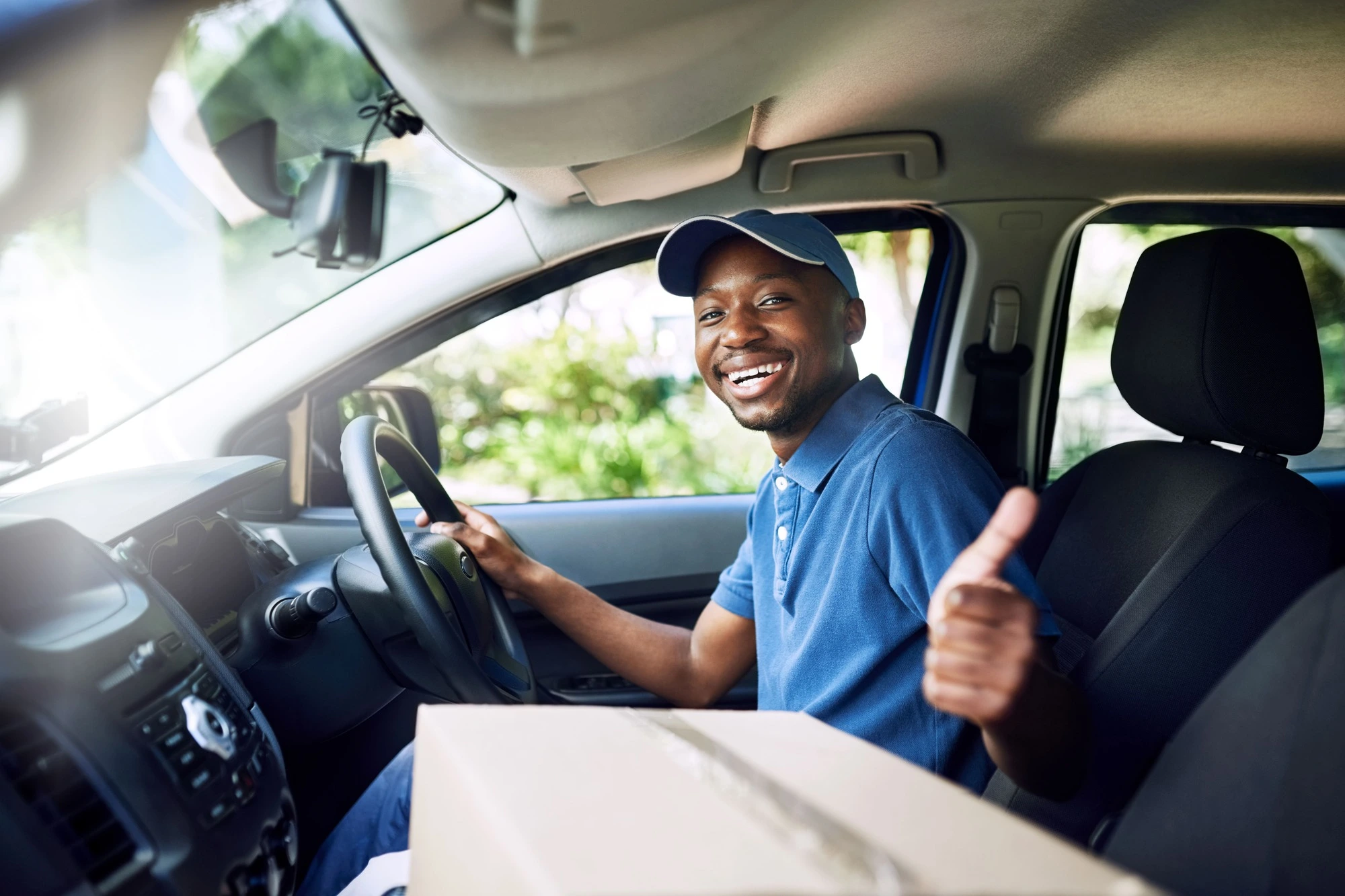 Driver with courier car insurance smiling at the camera