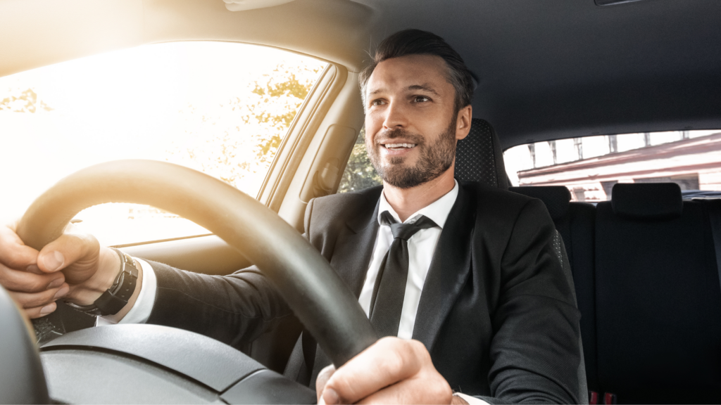 Guy driving as company car to work.