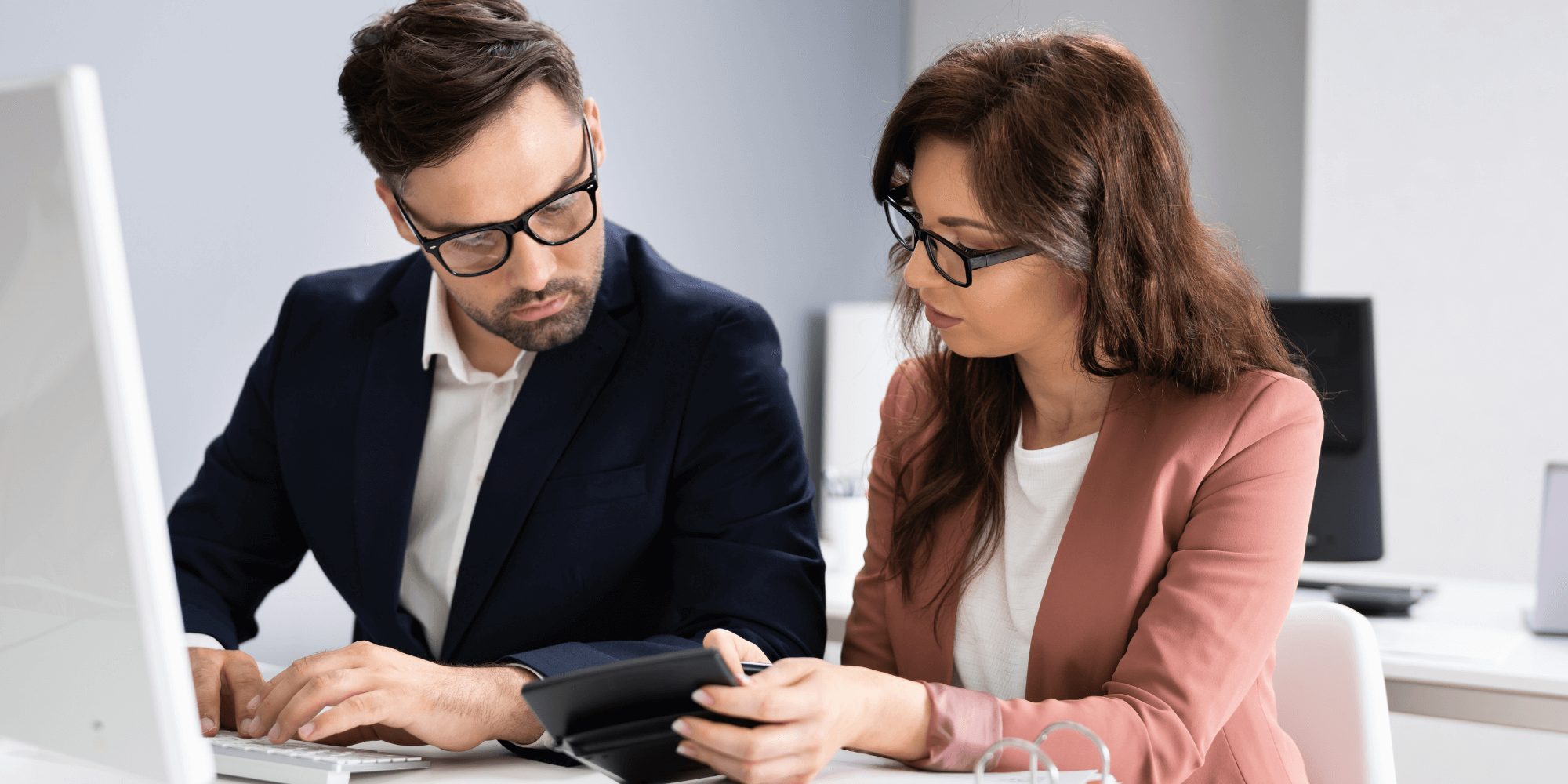 Professional accountant meeting with a client in a modern office setting.