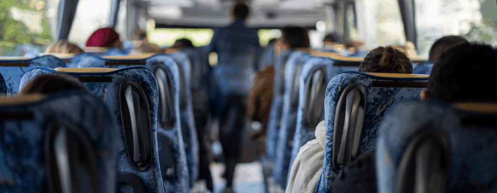 Interior of a minibus filled with passengers, representing the importance of Mini Bus Insurance for safe and protected travel.