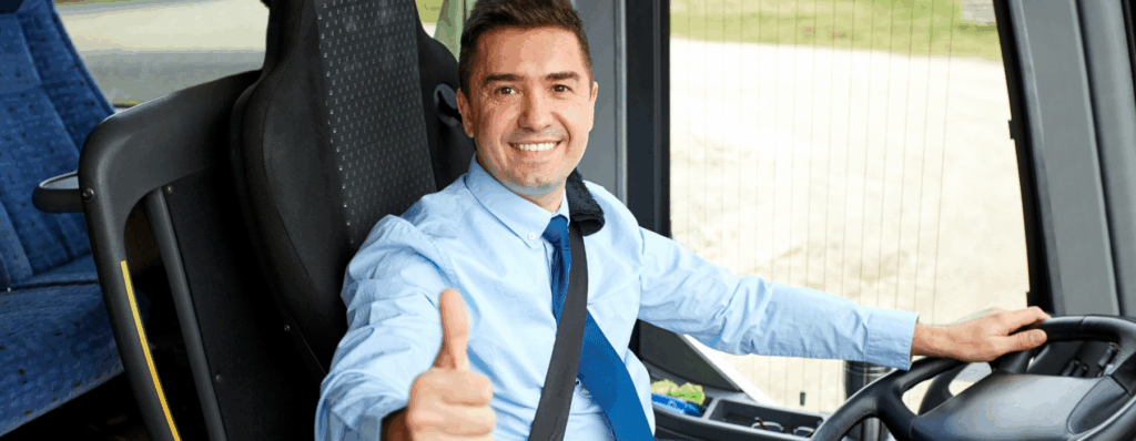 Smiling minibus driver giving a thumbs up, representing the safety and confidence provided by Mini Bus Insurance for operators and drivers.