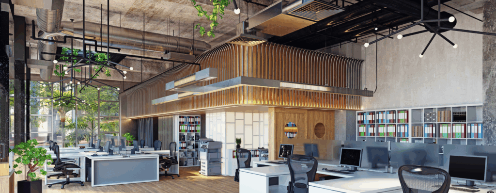 Stylish modern open-plan office with natural light and greenery, representing the type of space protected by Commercial Property Insurance for UK businesses.