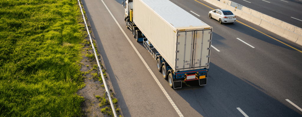 A lorry driving on a motorway carrying goods, representing UK haulage and transport insurance