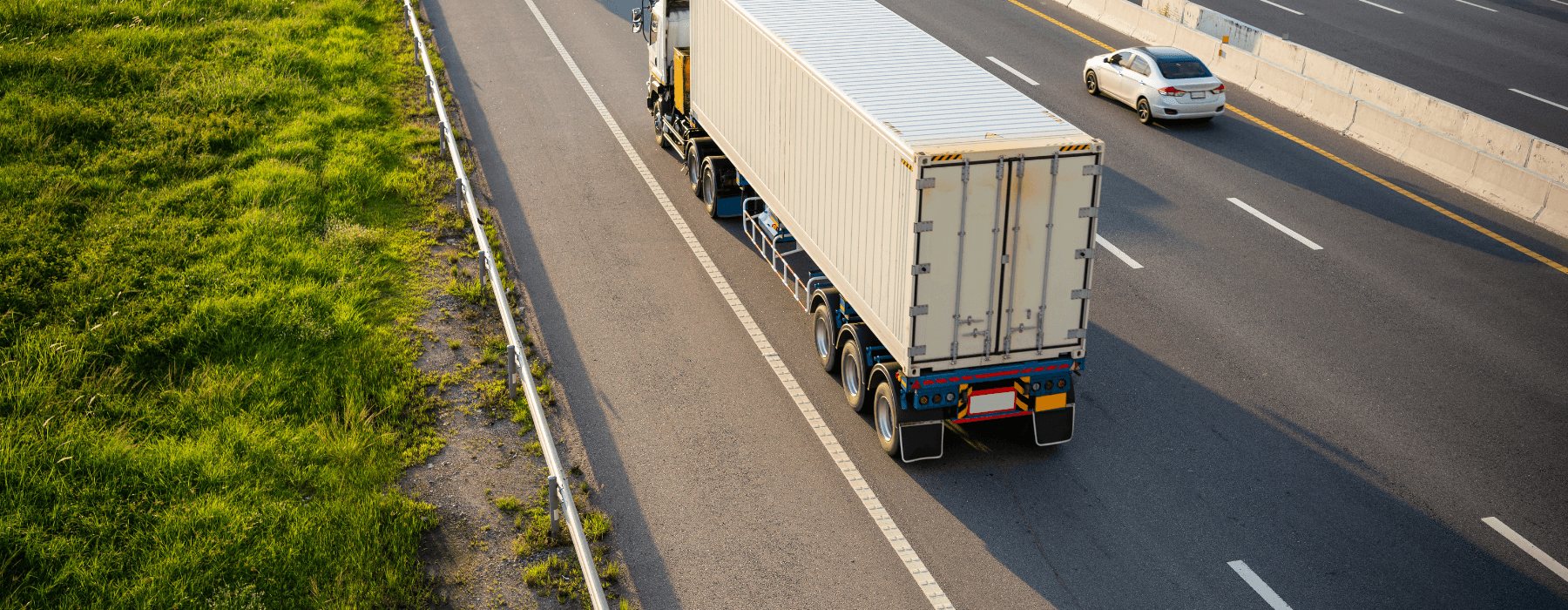 A lorry driving on a motorway carrying goods, representing UK haulage and transport insurance
