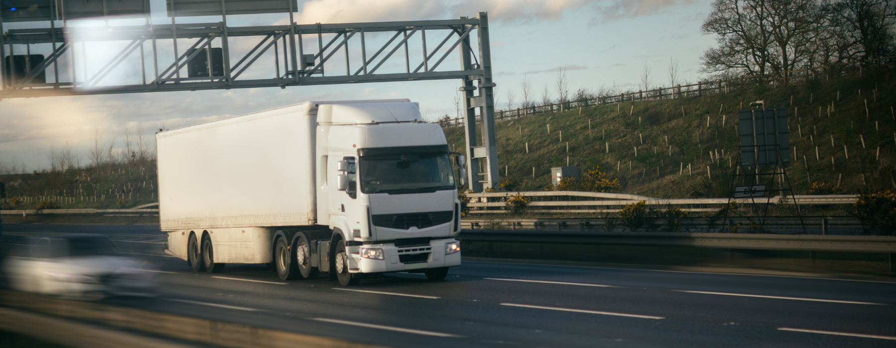 White HGV truck on UK motorway – representing haulage fleet insurance and logistics cover.