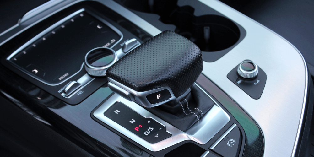 Automatic car gear selector and centre console, representing modern insured vehicle interiors