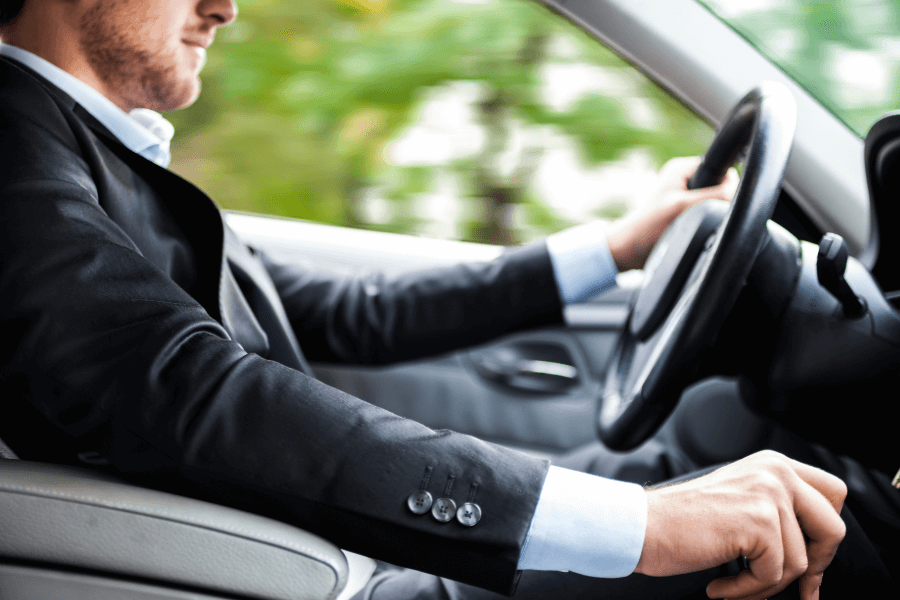Business driver inside a car, representing insured business and work vehicle use