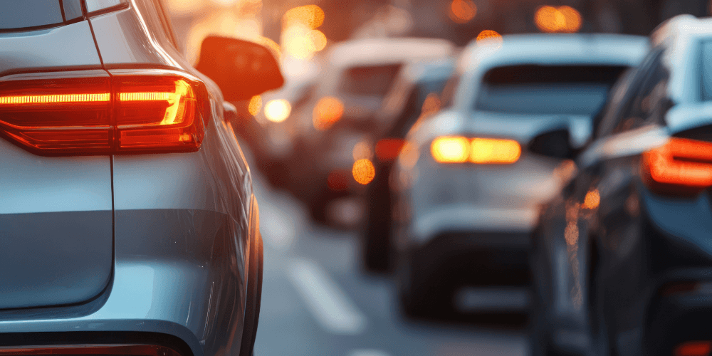 Cars stopped in traffic with brake lights illuminated, representing everyday insured driving conditions