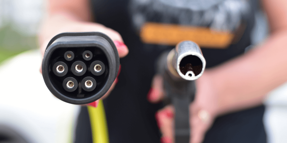 Close-up of an electric vehicle charging connector and cable, representing insured electric car charging