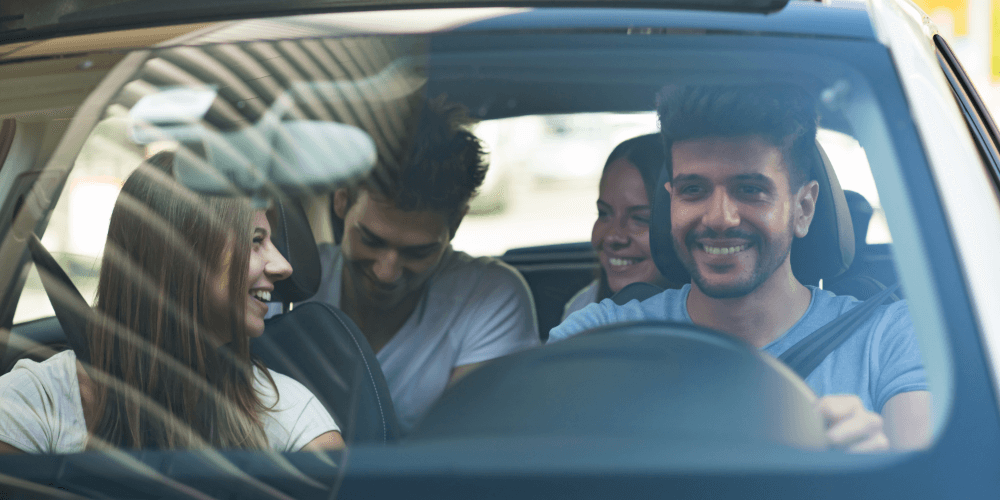 Group of friends travelling together inside a car, representing insured social and leisure driving