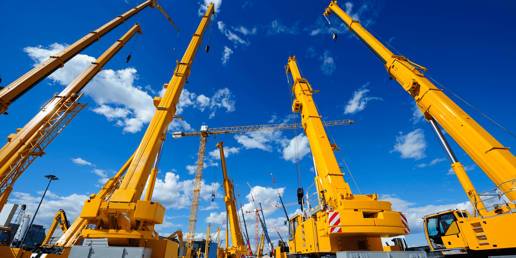 Mobile cranes lifting materials on a large construction site