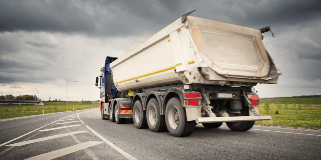 Heavy tipper lorry operating on public road under insured commercial vehicle cover
