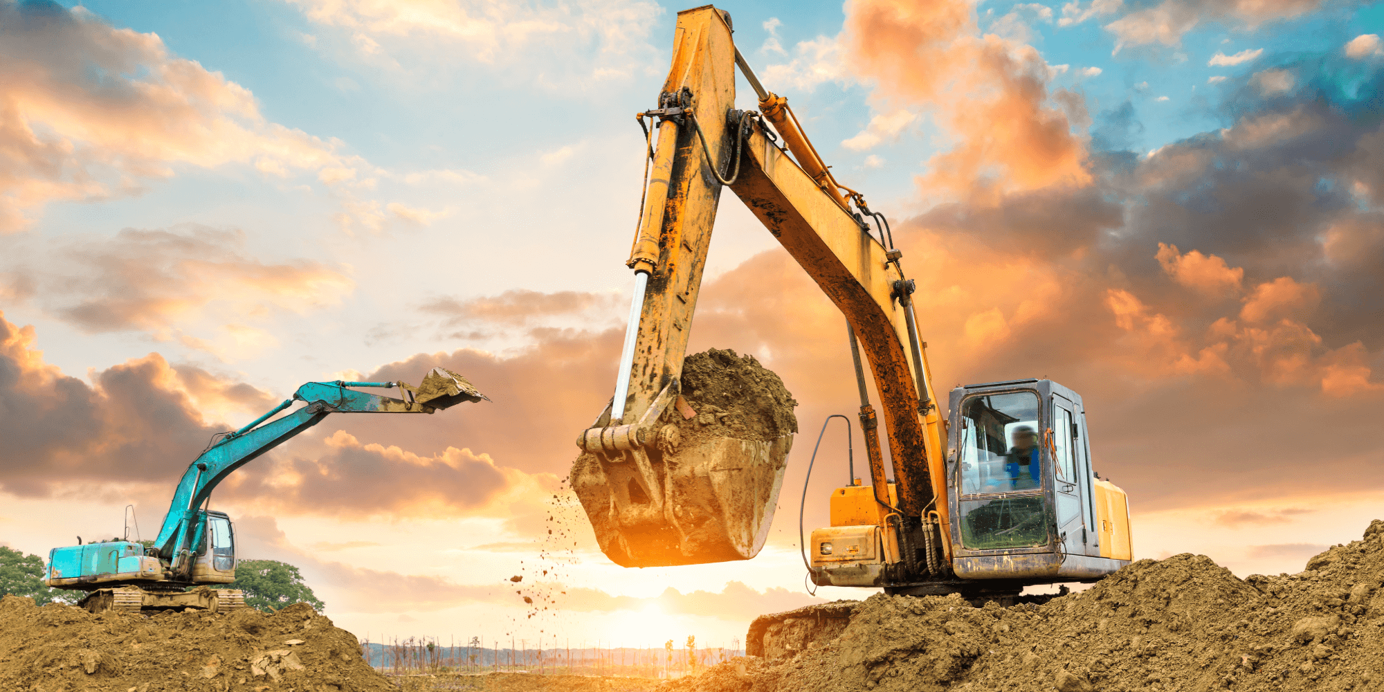 Heavy excavators carrying out insured earthmoving and groundworks operations on site