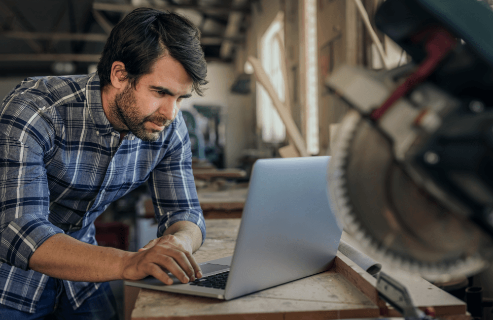 tradesman-on-computer-in-workshop