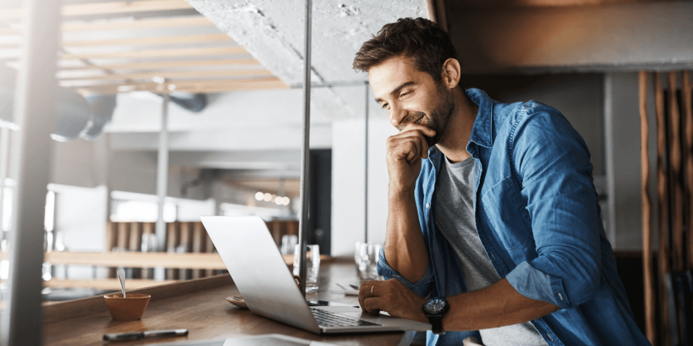 man on computer doing marketing for his startup company
